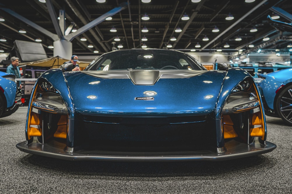 a blue sports car parked inside of a building