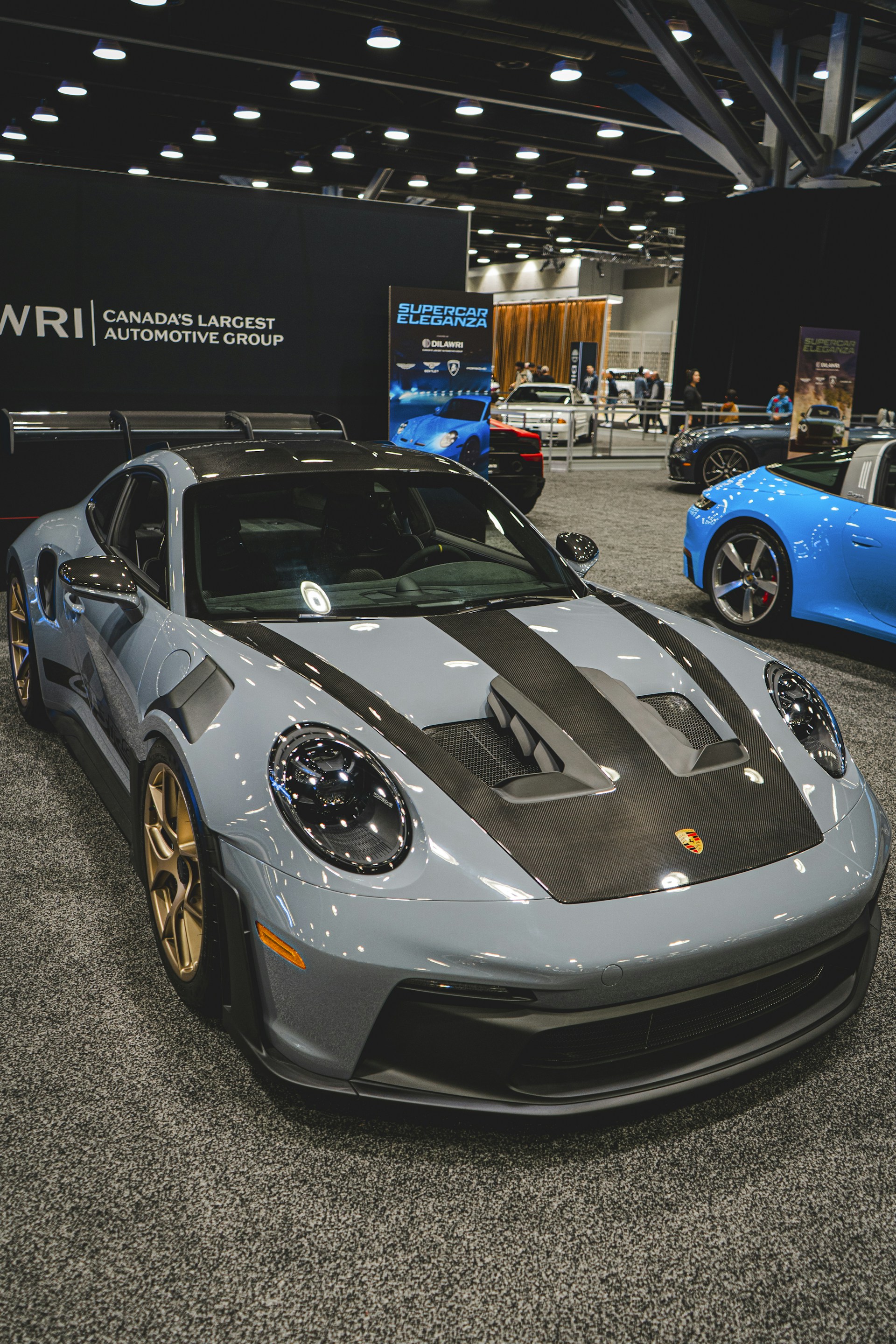 a silver and black sports car on display at a car show