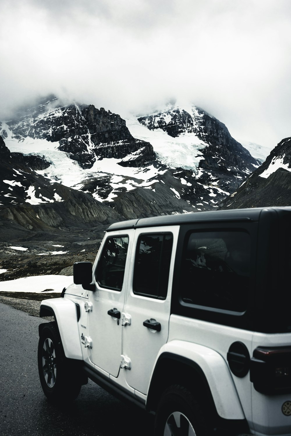 a white jeep parked on the side of a road