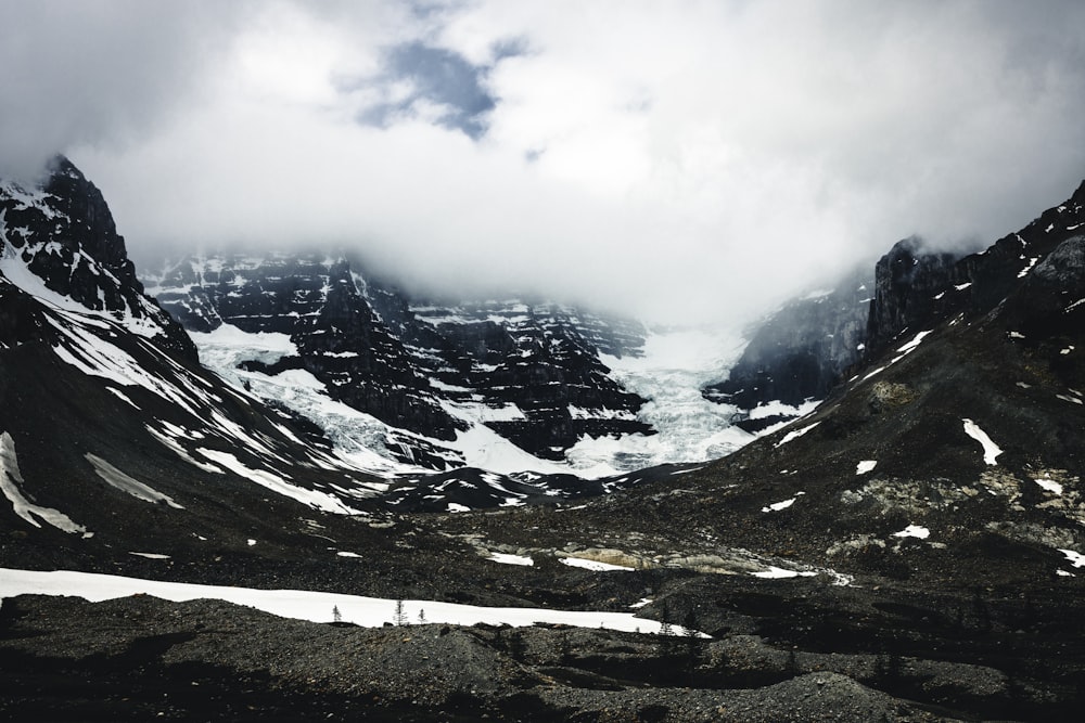 a group of people standing on top of a snow covered mountain