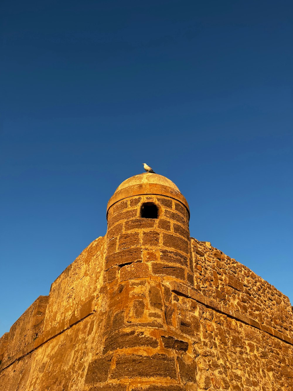 a tall brick tower with a sky background