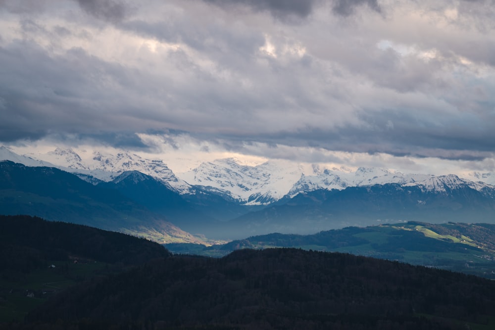 a view of a mountain range with snow capped mountains in the distance