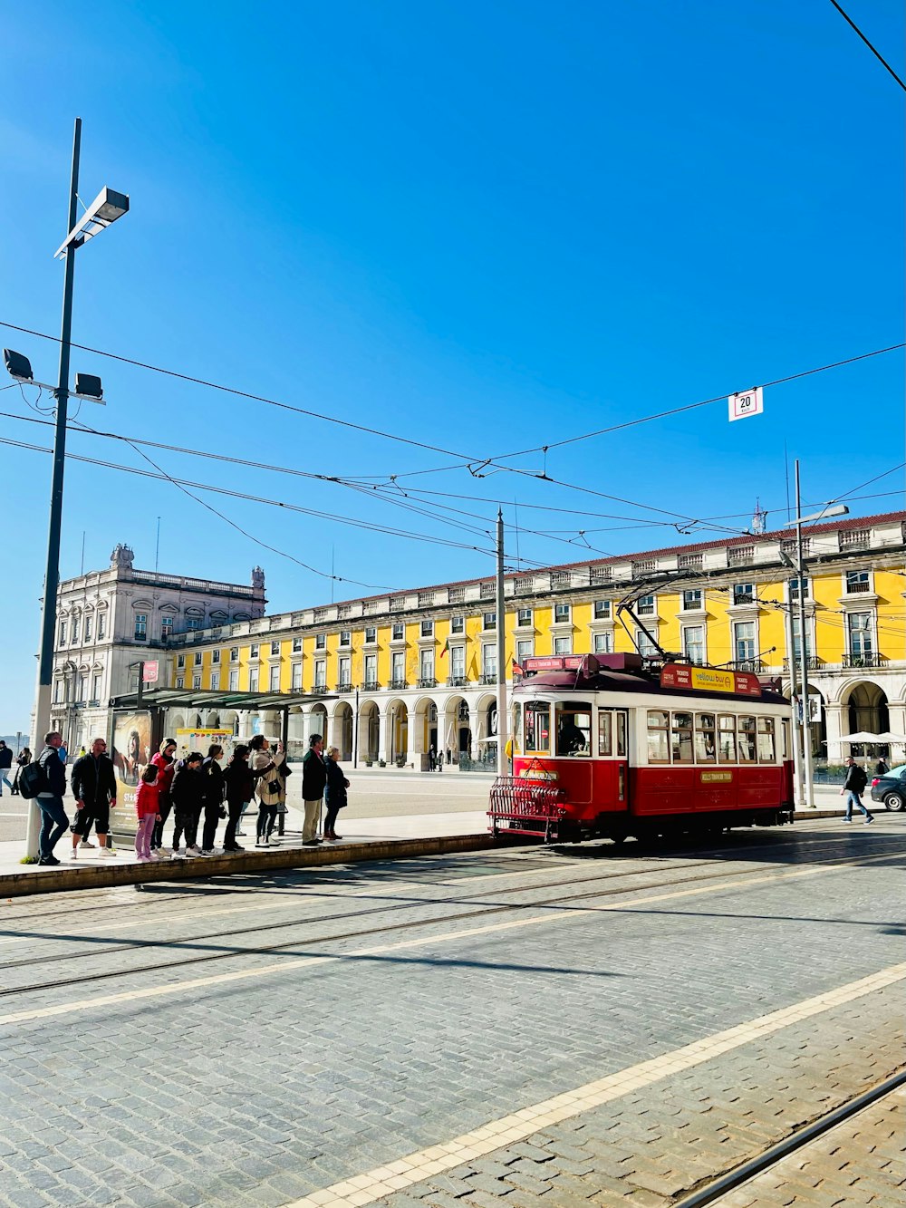 a red and white trolley on a city street