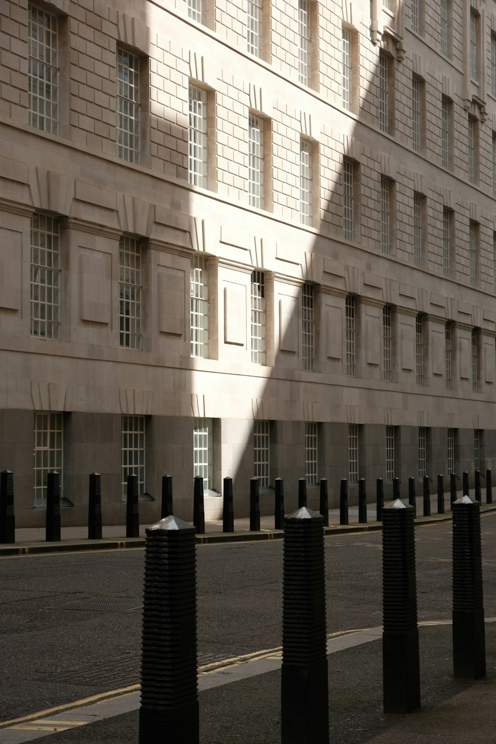 the shadow of a building on a street