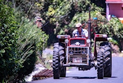 a man driving a tractor down a street