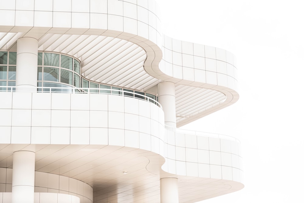 a tall white building with a clock on it's side