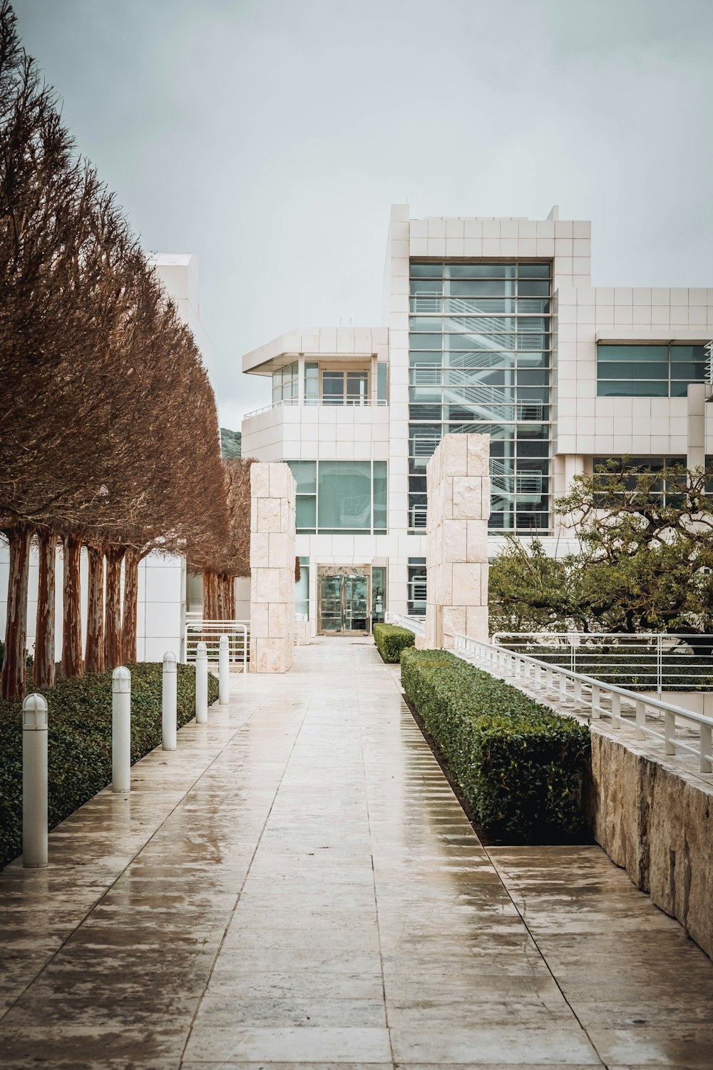 a walkway leading to a building with a clock on it