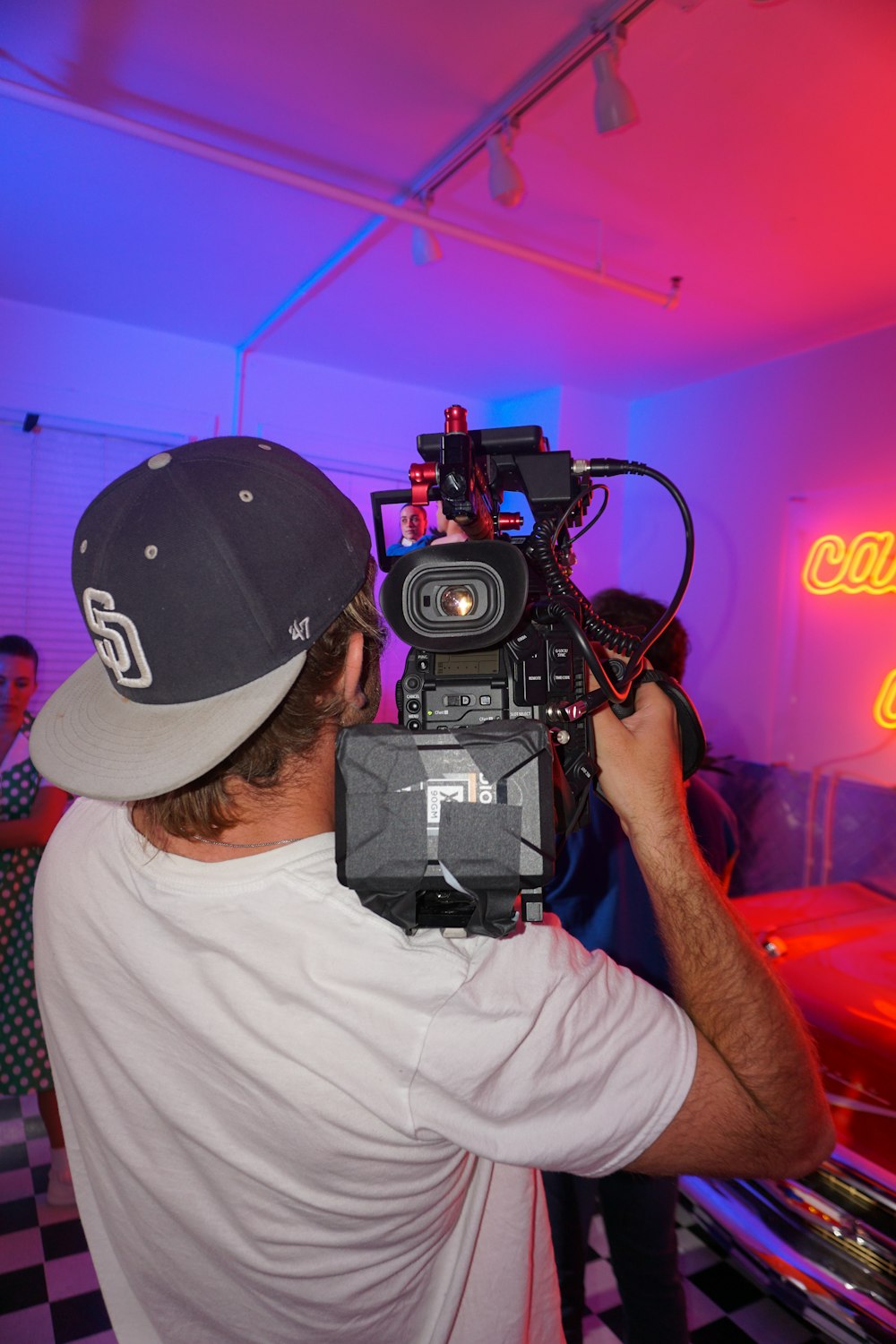 a man holding a video camera in a room