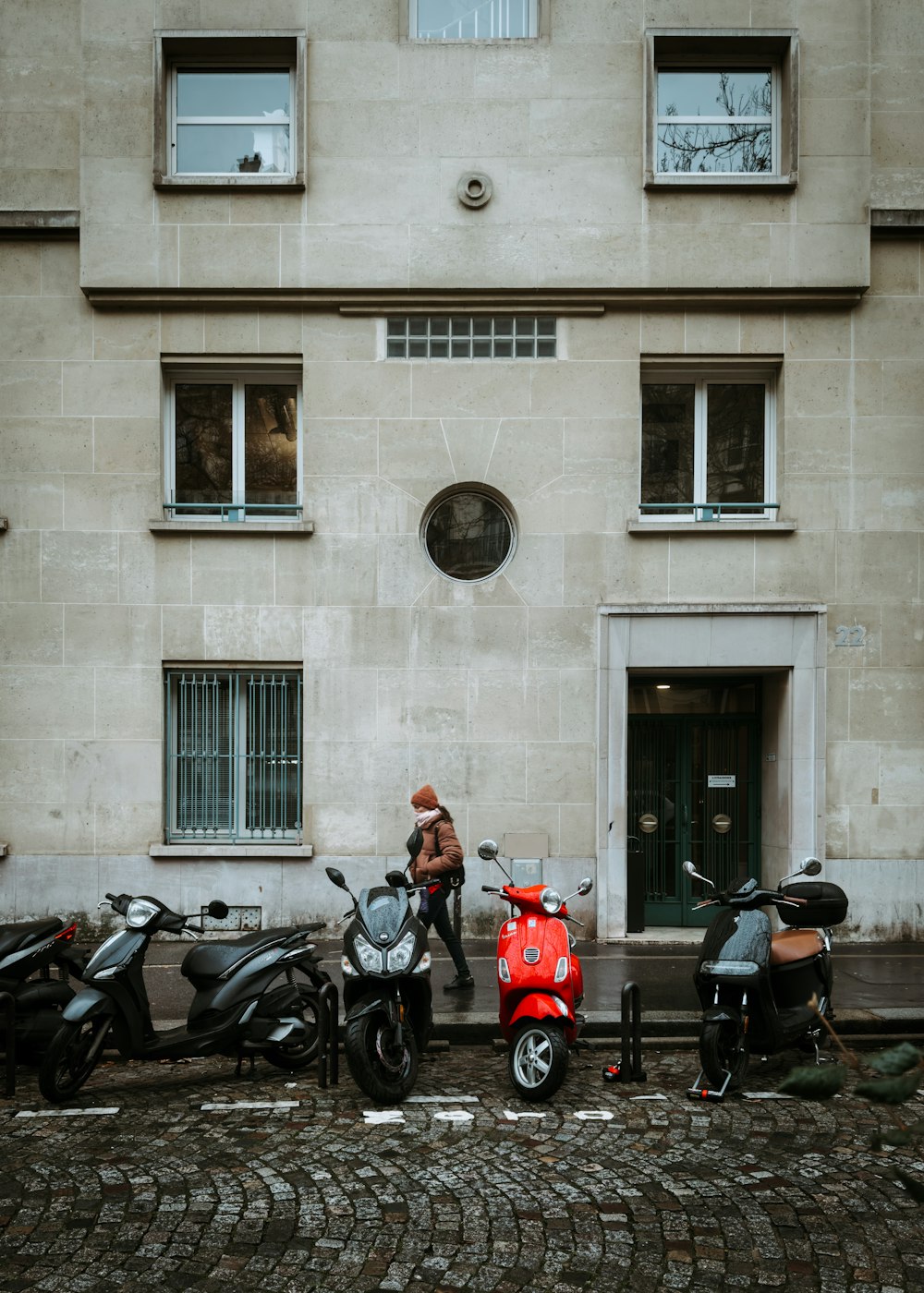 a group of scooters parked in front of a building