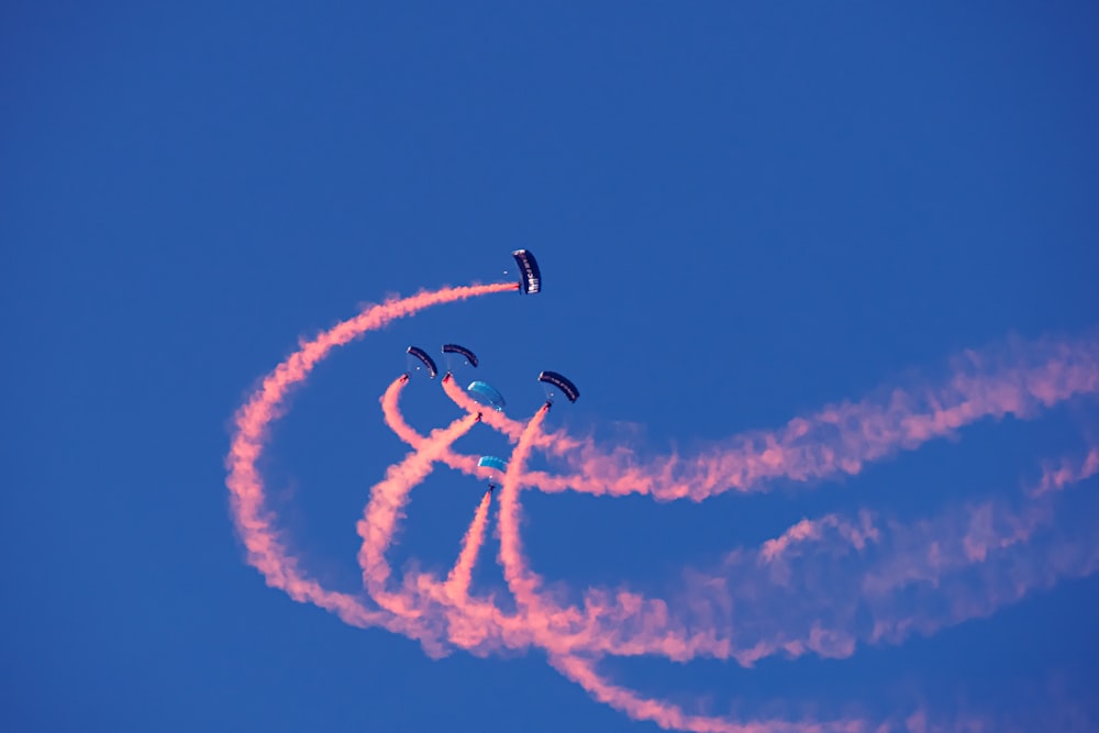 a group of people flying kites in the sky