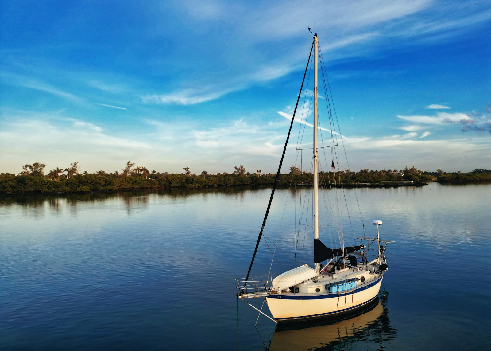 A sailboat floating on top of a body of water.