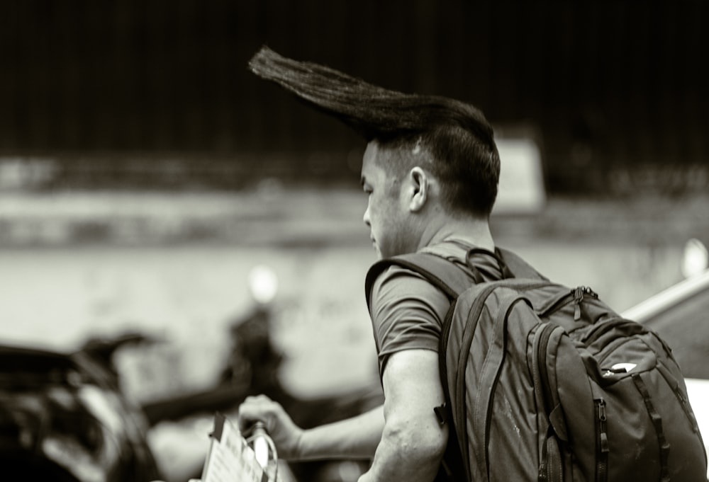 a man with a backpack and a mohawk on his head