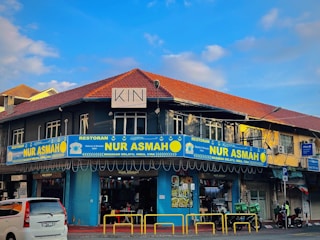 a blue and yellow building on a street corner