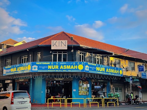 a blue and yellow building on a street corner