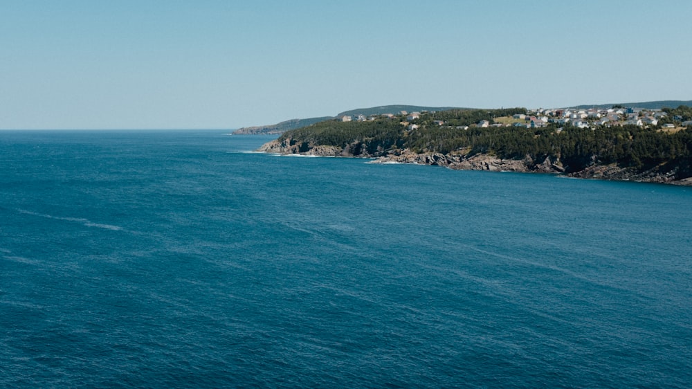 a body of water with a small town in the distance