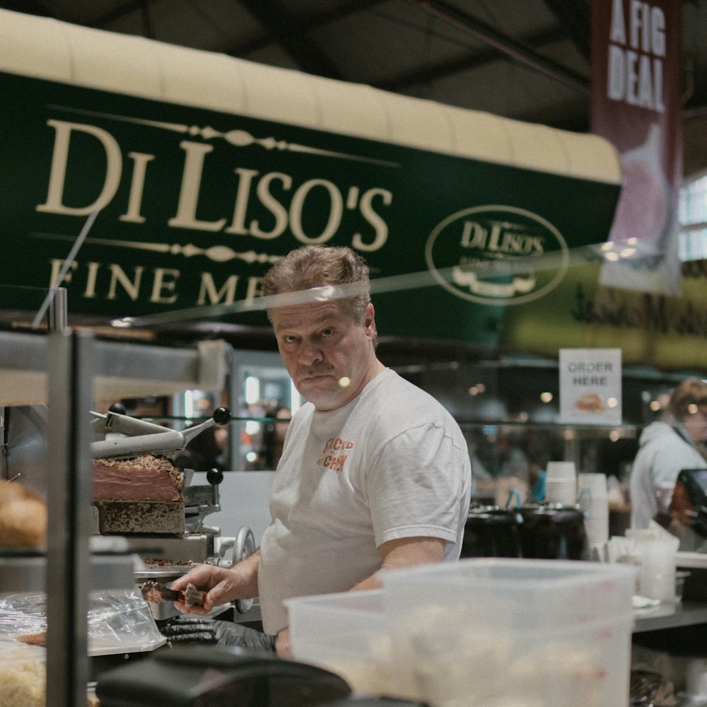 a man standing in front of a counter preparing food