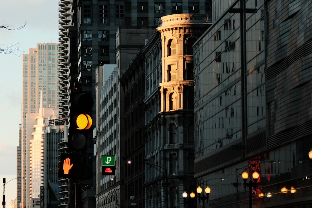 a traffic light on a city street next to tall buildings