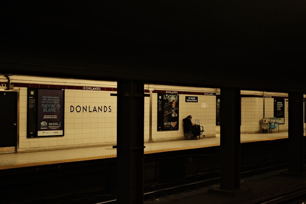 a subway station with people waiting for the train