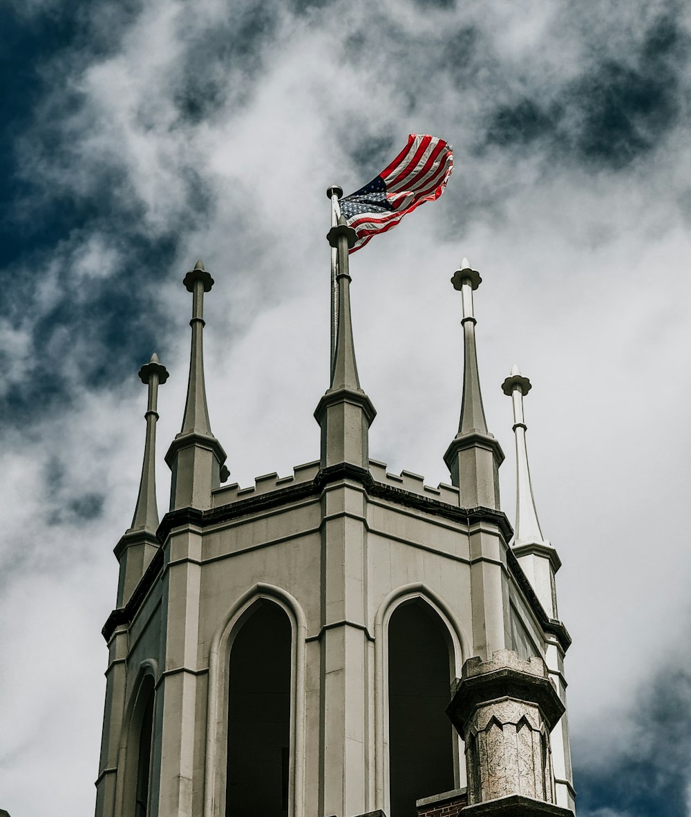 an american flag flying on top of a building