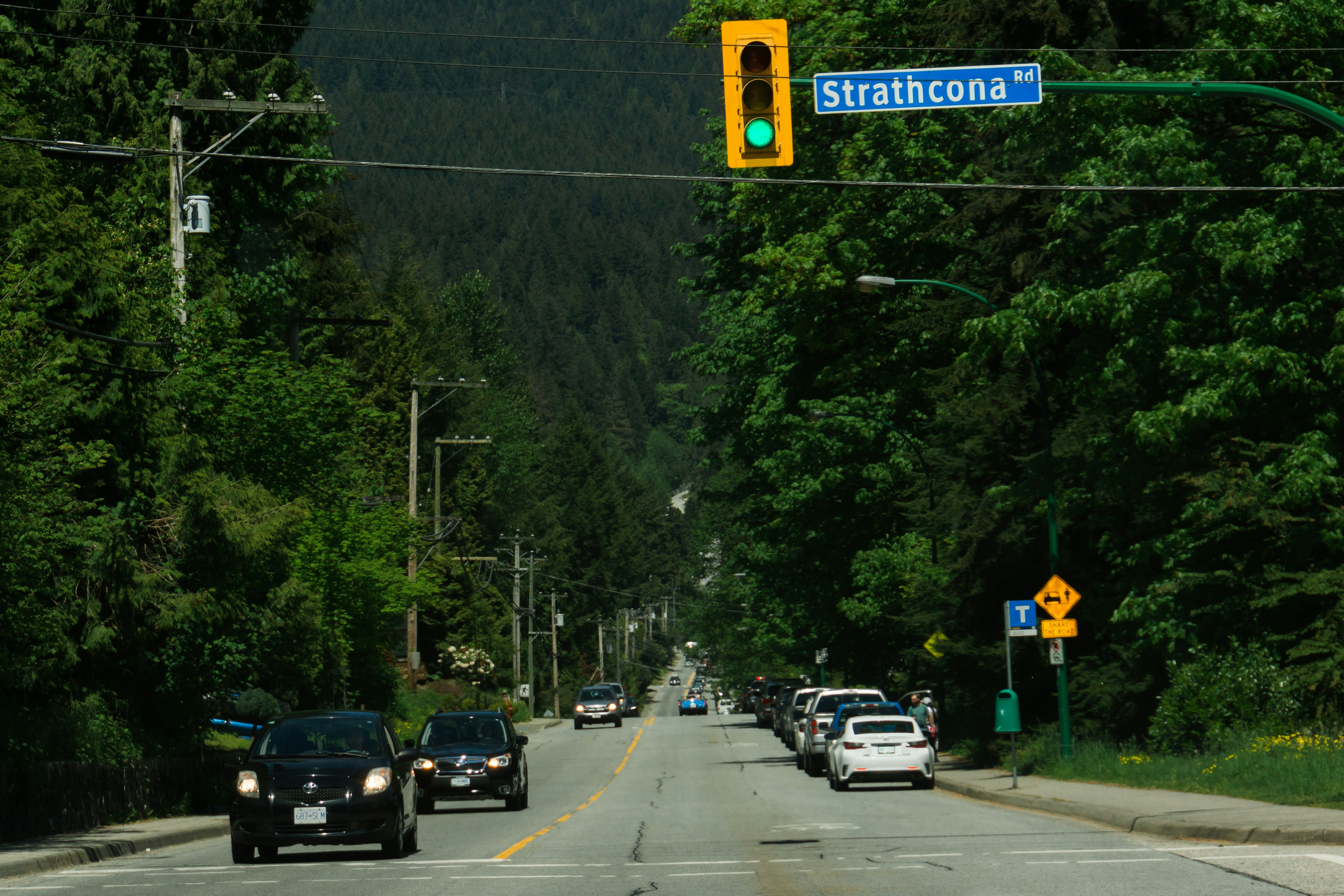a traffic light hanging over a street filled with traffic