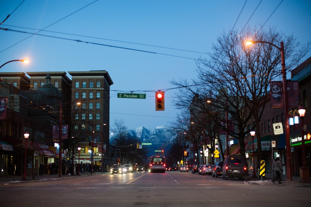 a red traffic light hanging over a city street