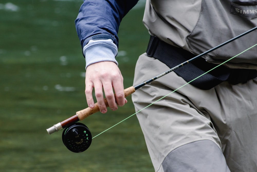 a man holding a fishing rod and a fishing pole
