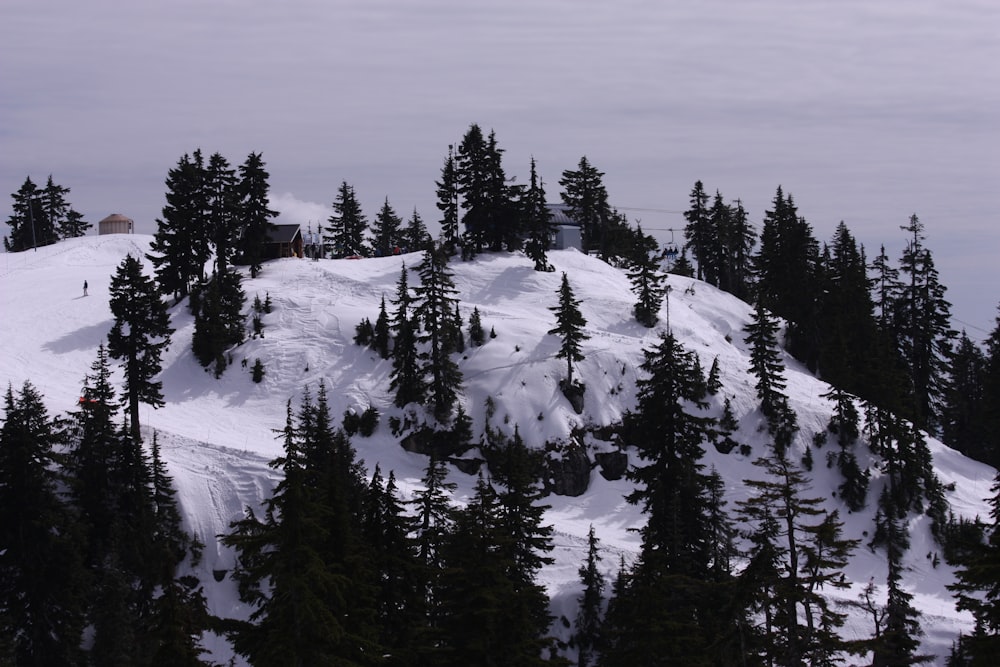 a snow covered mountain with a ski lift in the distance