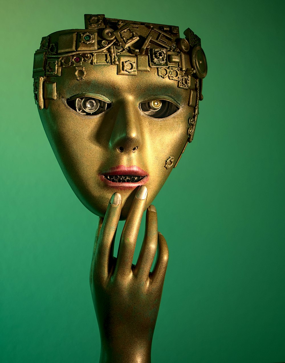 a woman's face with a gold mask on her head