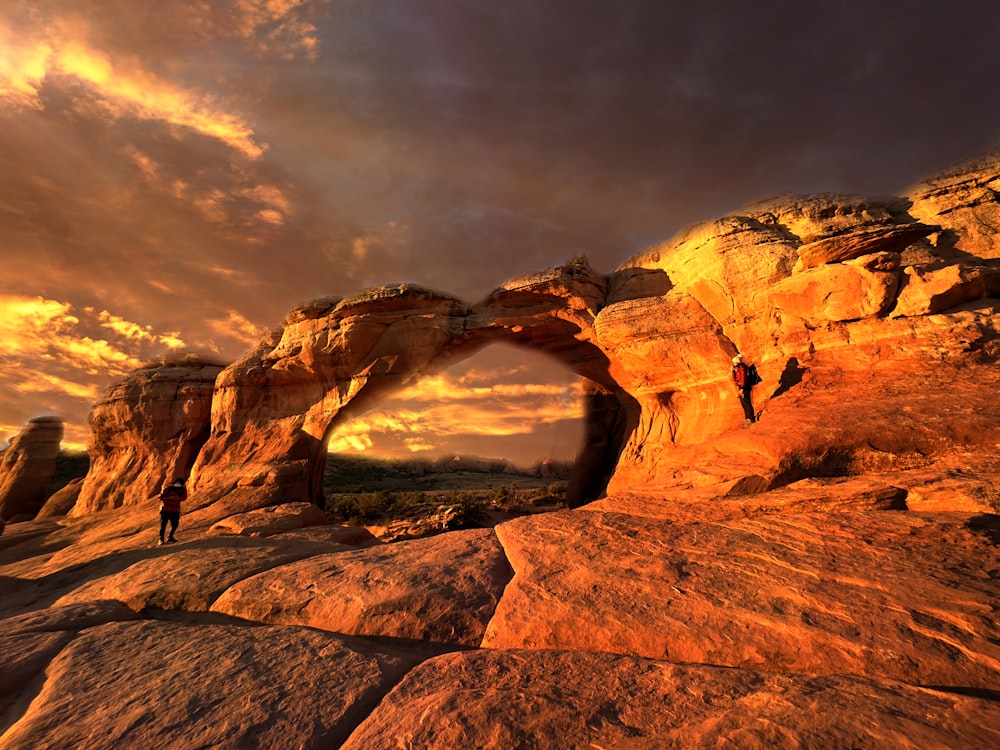 a man standing on top of a large rock formation