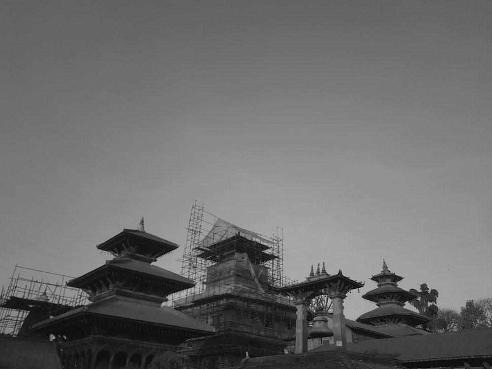 a black and white photo of a building under construction