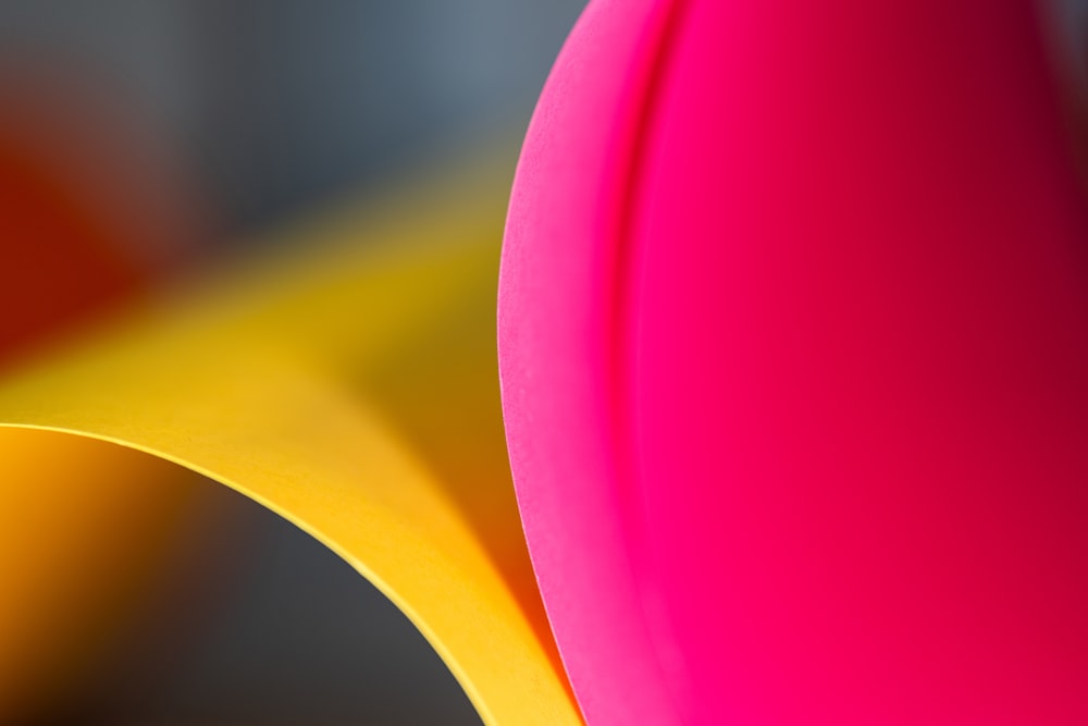 a close up of a pink and yellow object