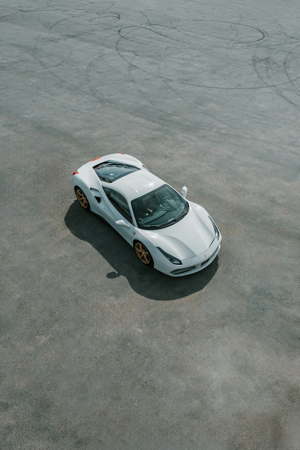 a white sports car parked in a parking lot