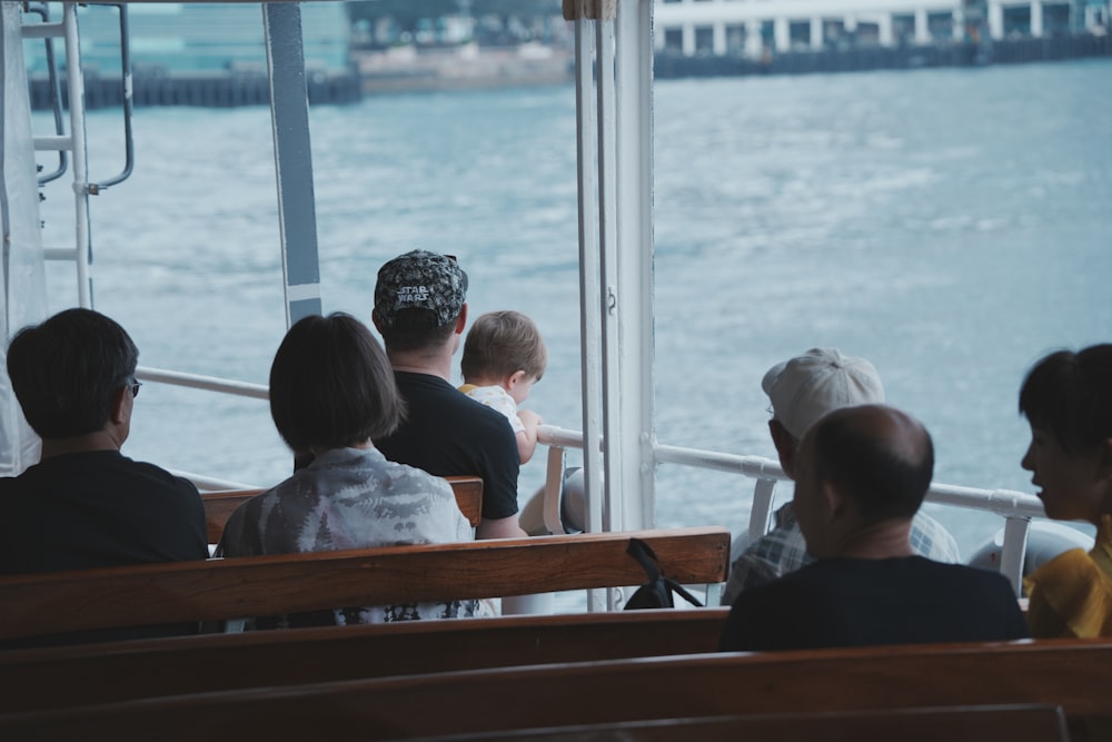 a group of people sitting on top of a boat