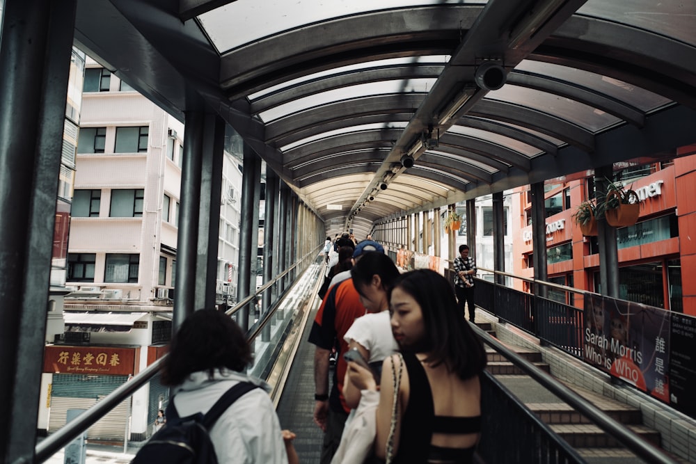 a group of people walking down a walkway