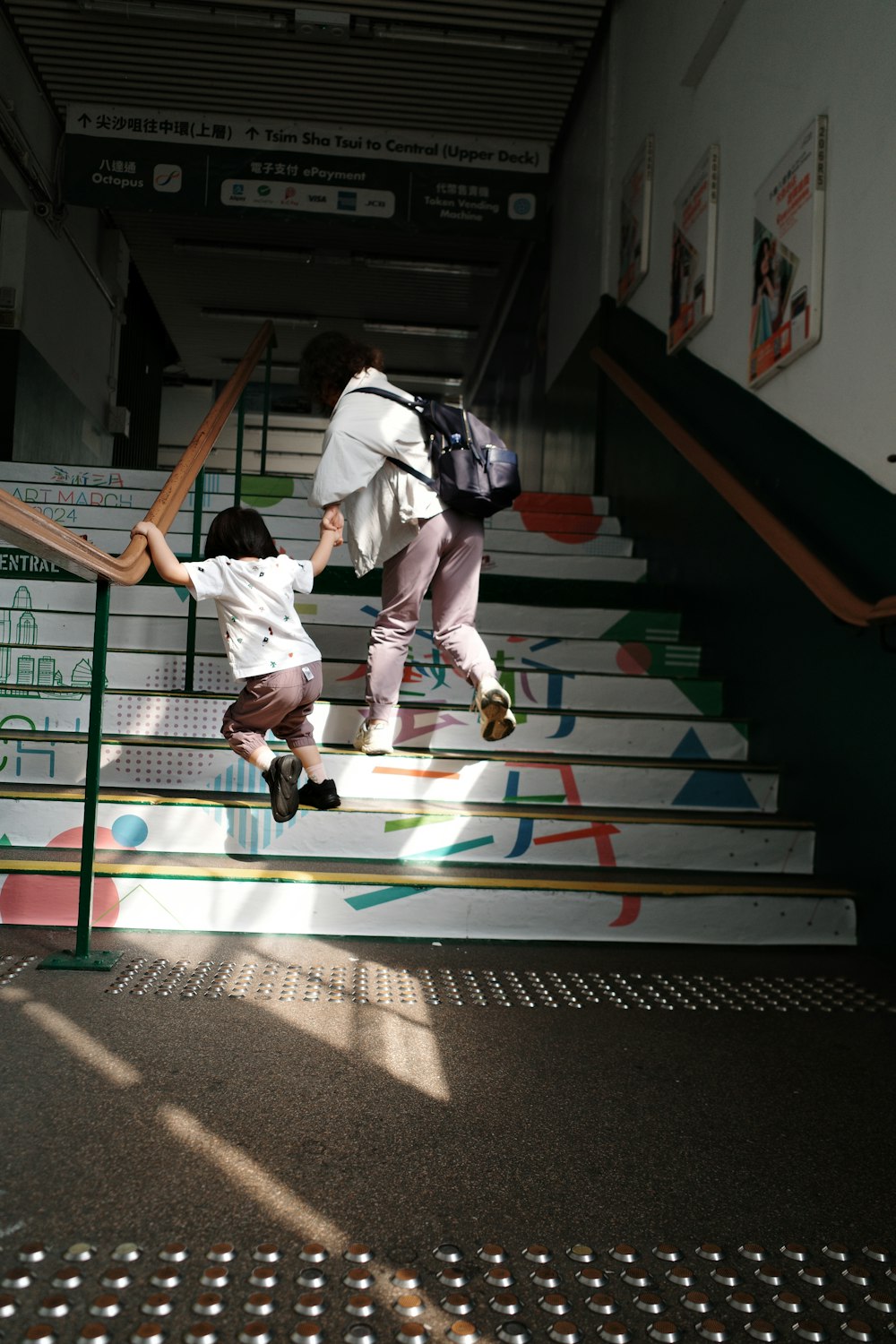 a couple of people that are walking up some stairs