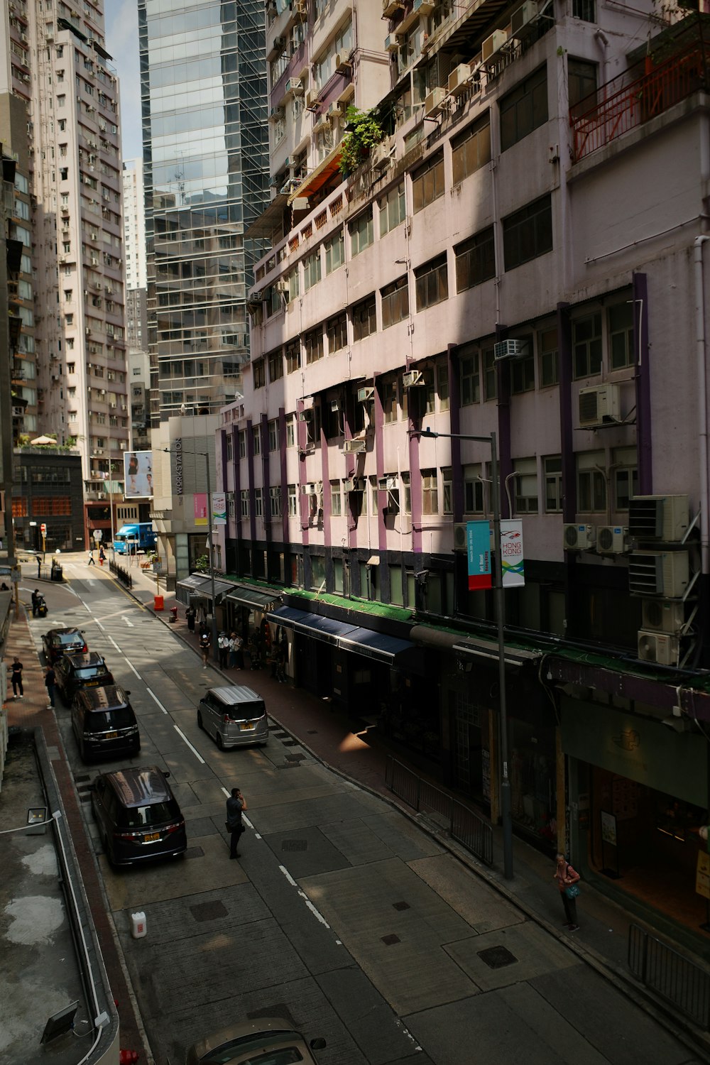 a city street filled with traffic next to tall buildings