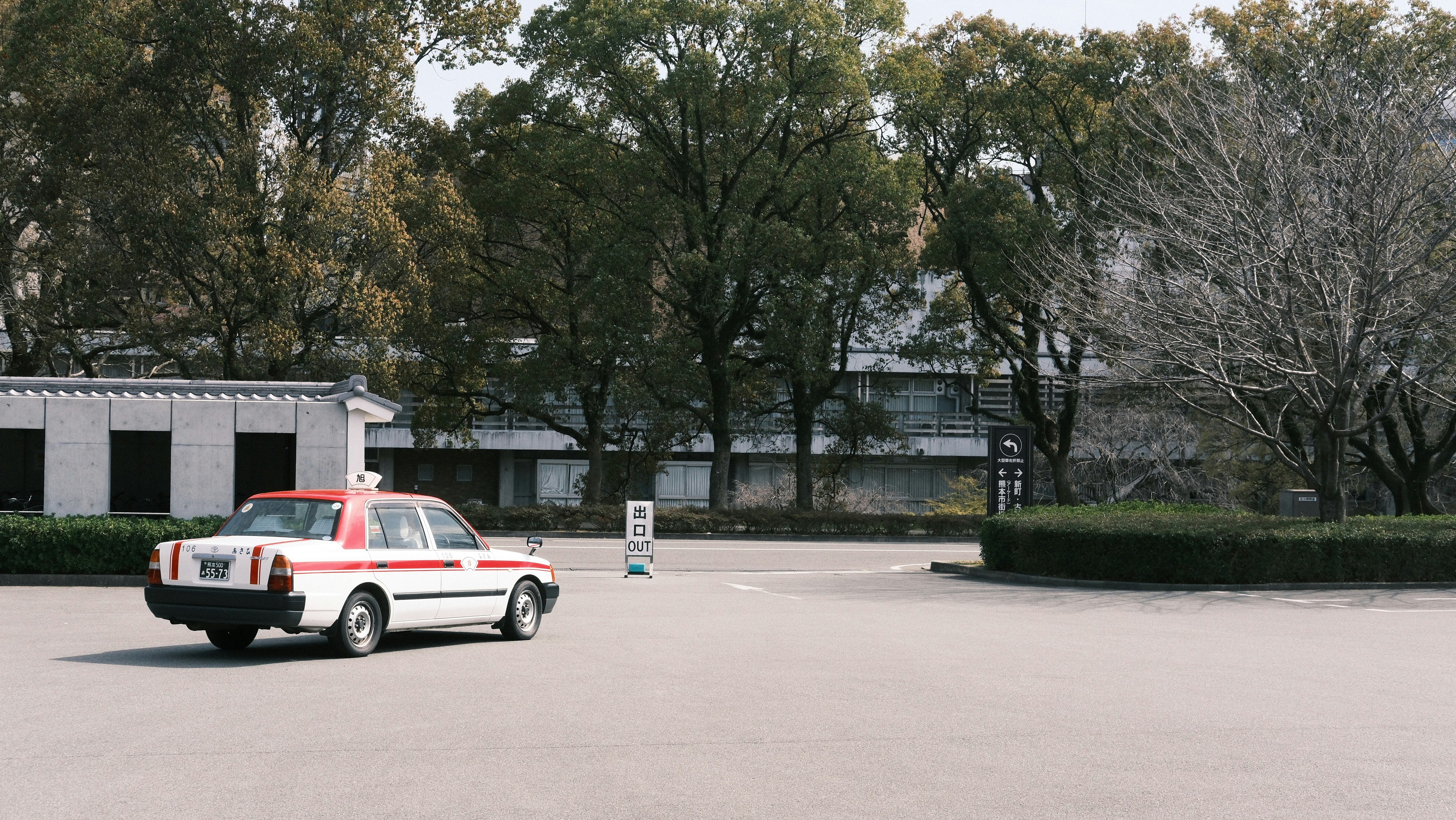 a red and white car parked in a parking lot