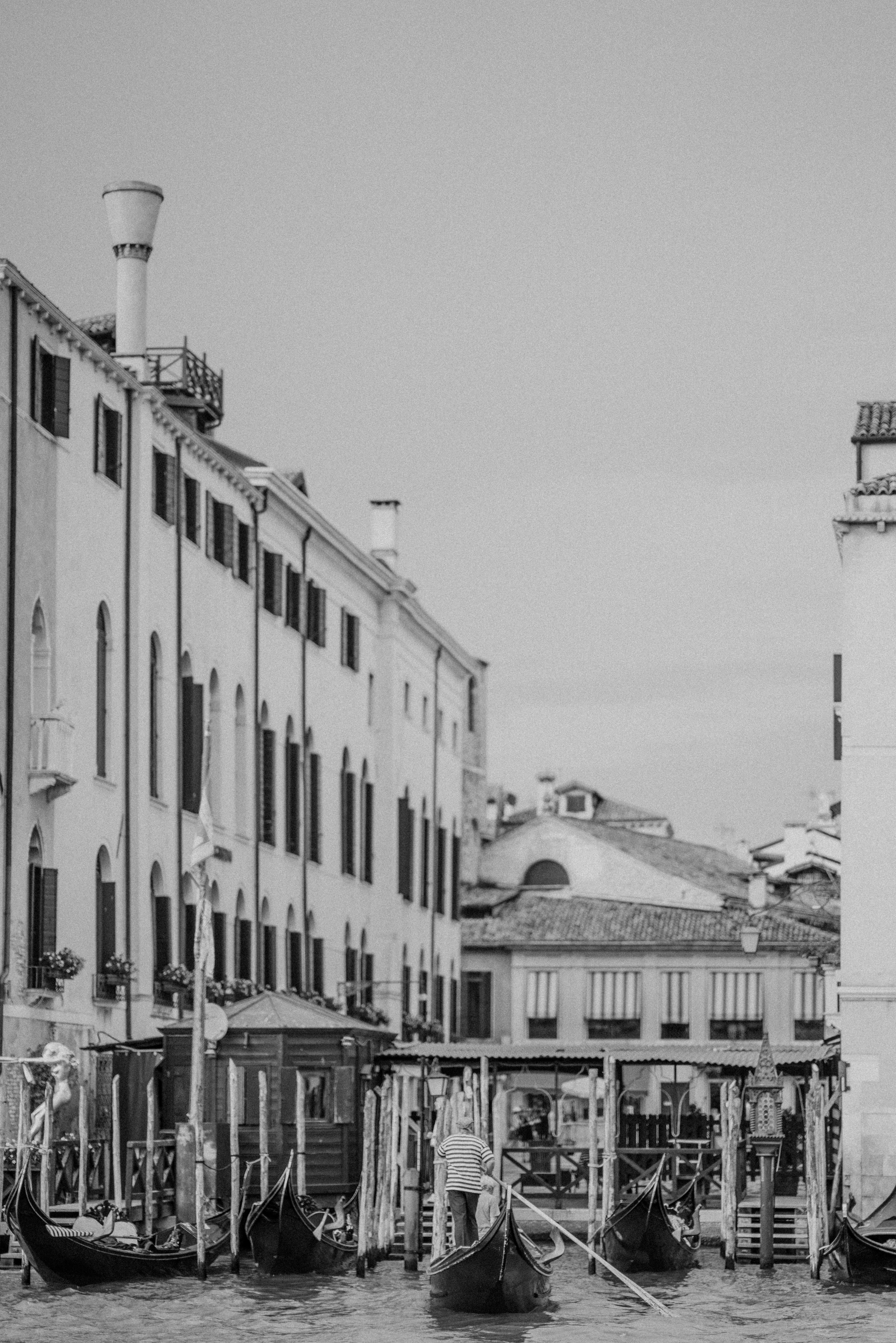 a black and white photo of gondolas and buildings