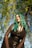 a woman with green hair and glasses posing for a picture