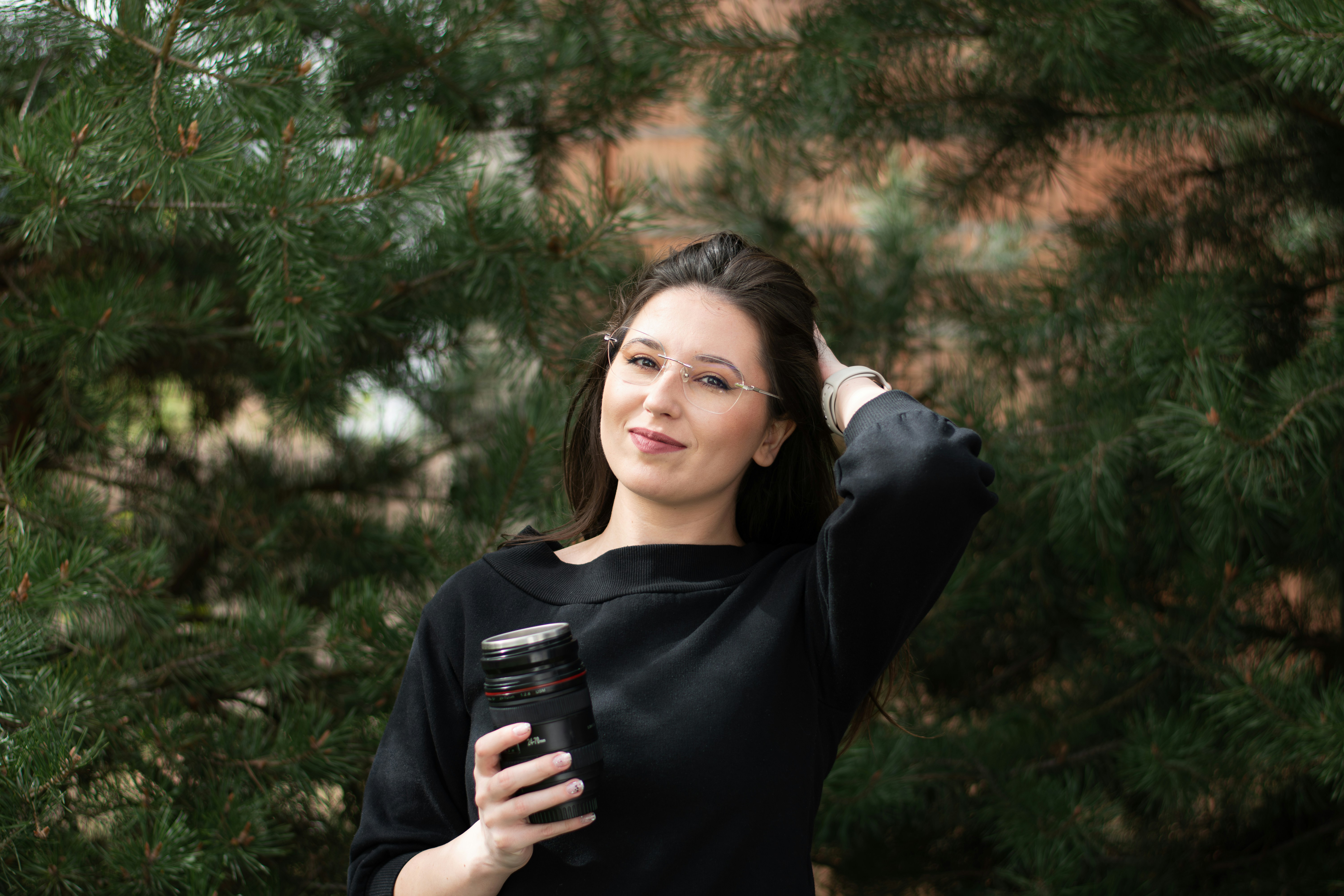 a woman holding a cup of coffee in her hand