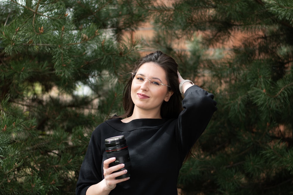 a woman holding a cup of coffee in her hand