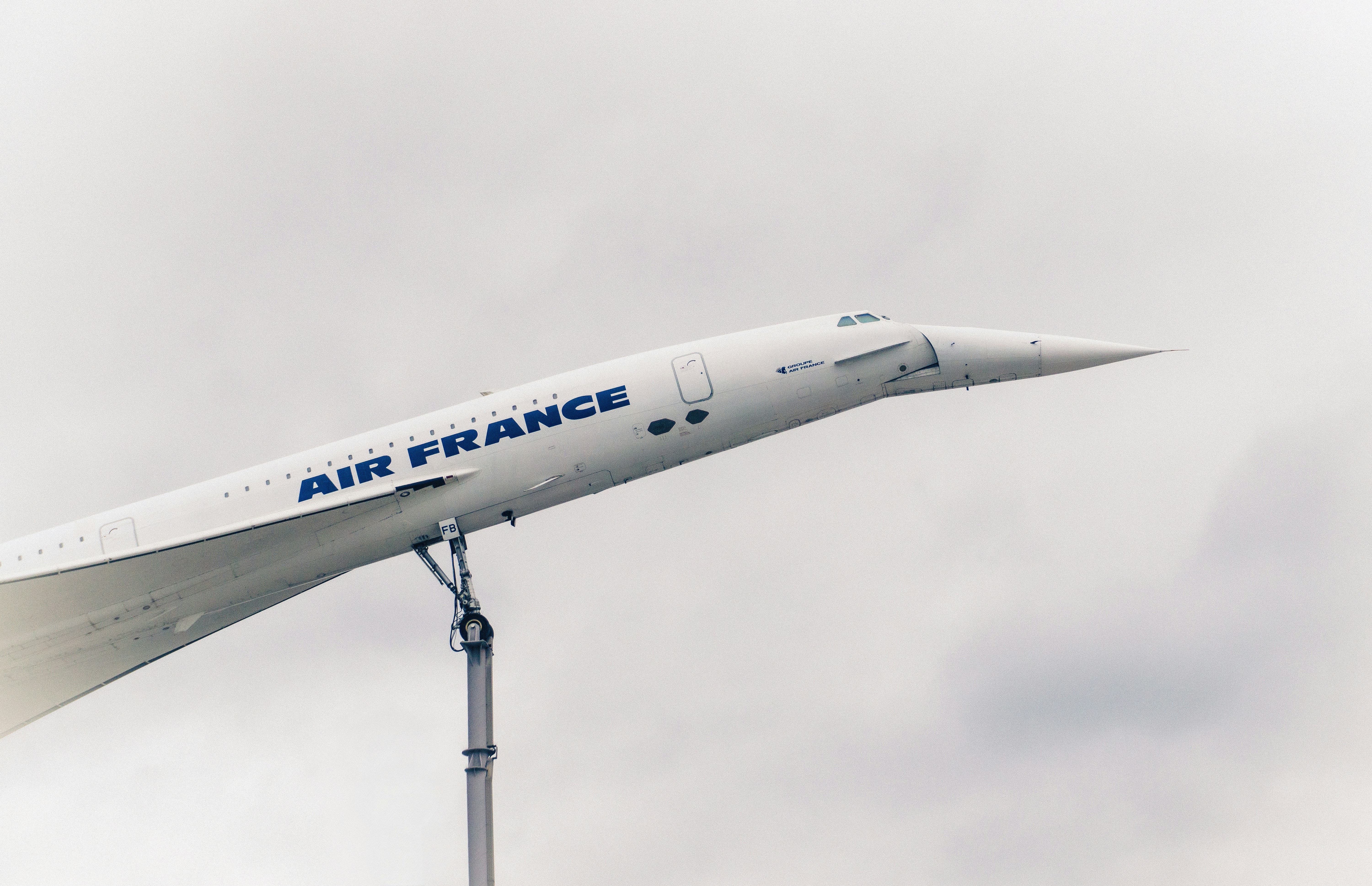 a large air france jet flying through a cloudy sky, 