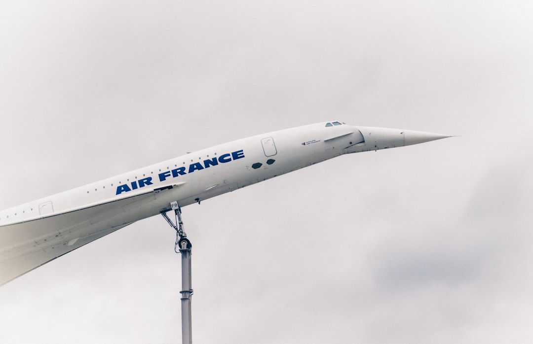 a large air france jet flying through a cloudy sky,