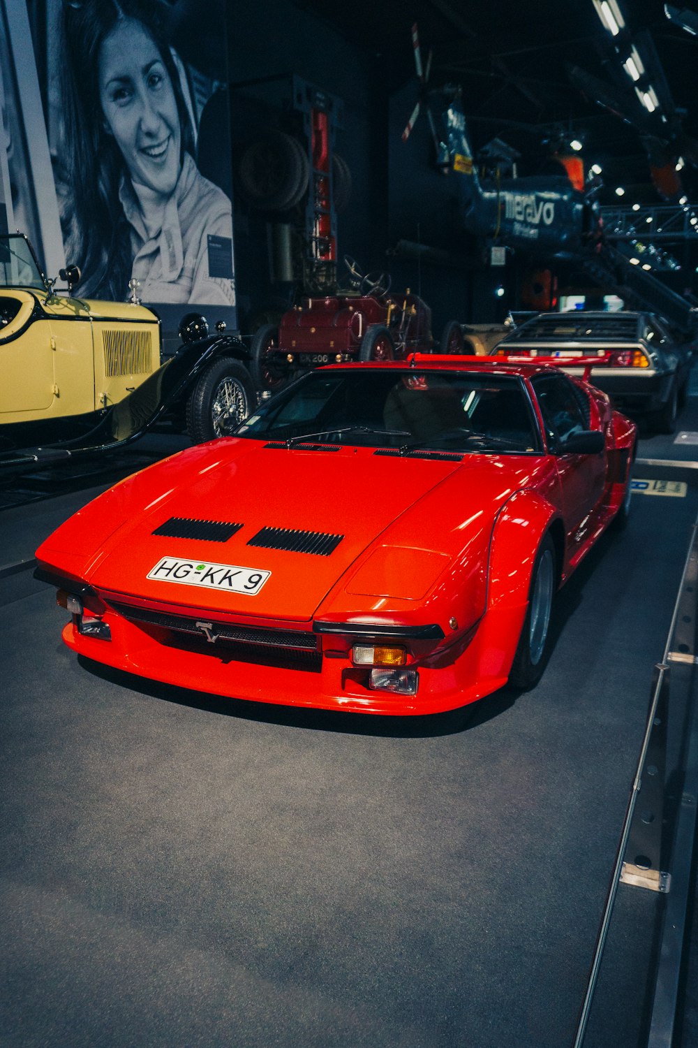 a red sports car on display in a museum