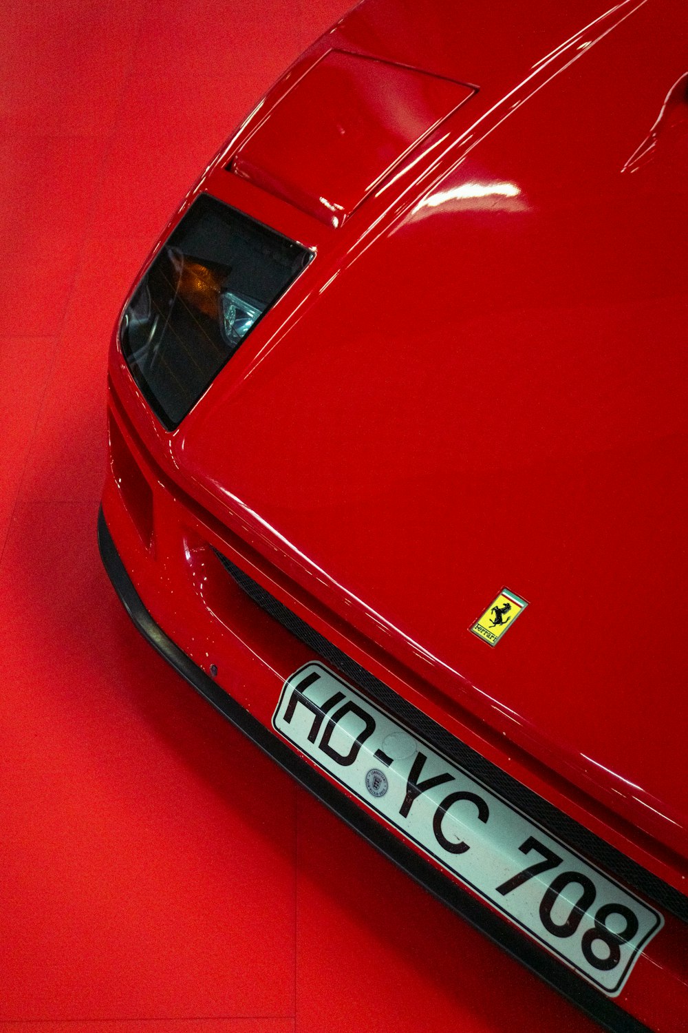 a close up of a red sports car on a red floor