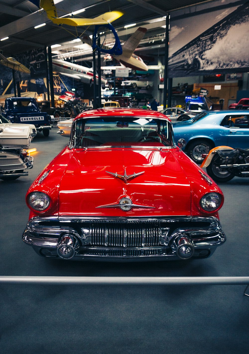 a red car is parked in a garage