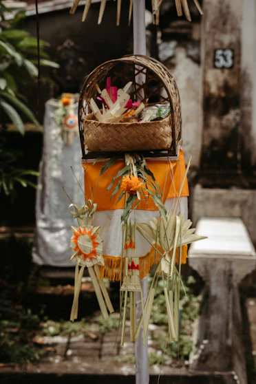 a basket of flowers hanging from a pole