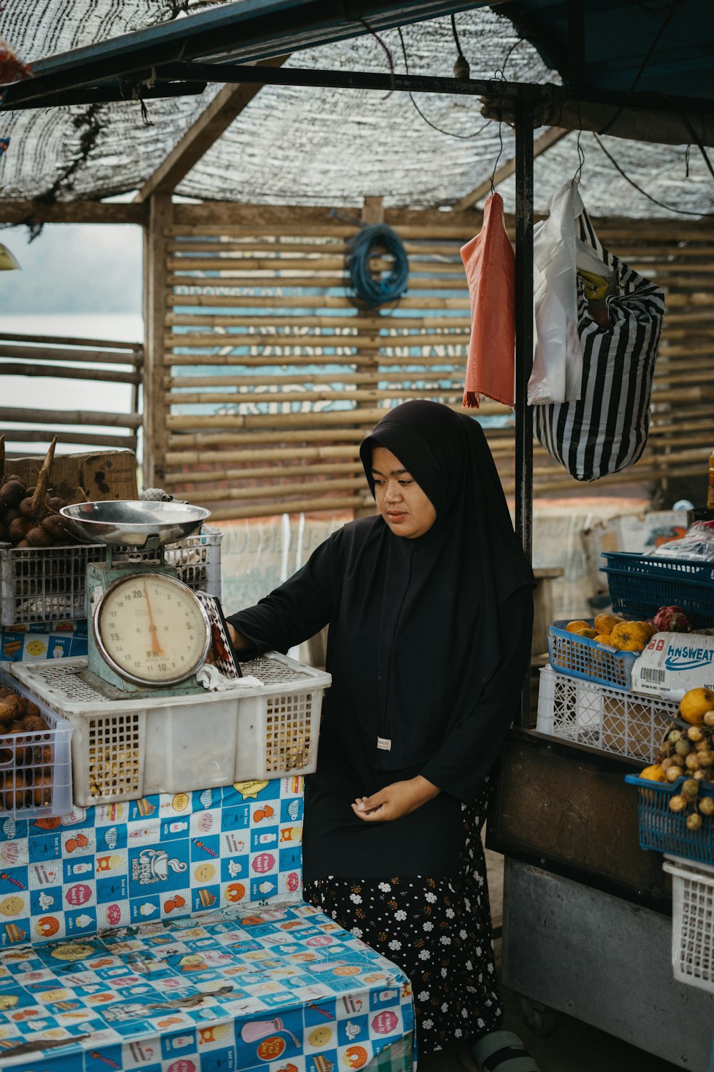 a woman standing next to a table with a clock on it