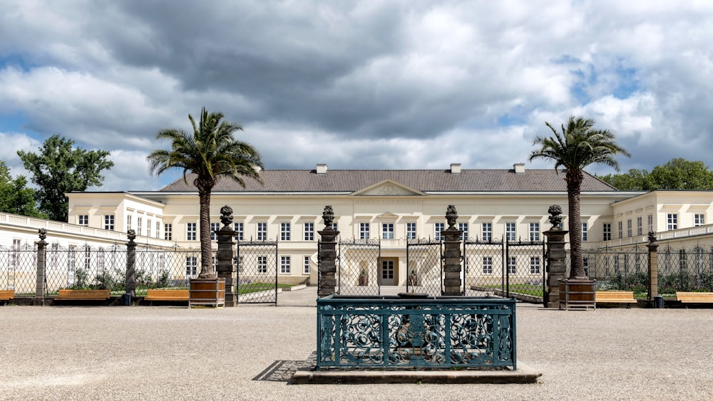 a large building with palm trees in front of it