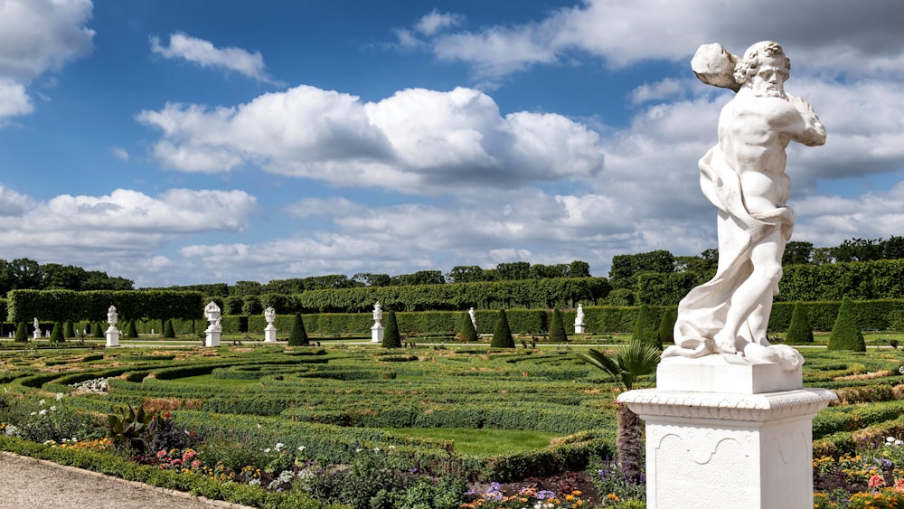 a statue of a man in a formal garden